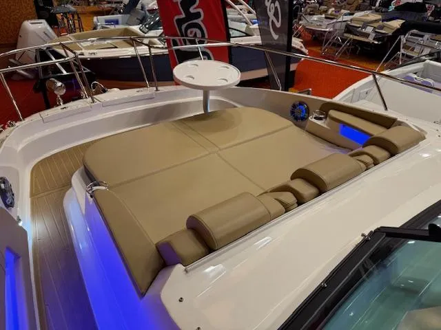 Slide: The Image of 2024 Sea Ray Sundancer 320 boat with spacious sunpad and modern interior lighting. - 11