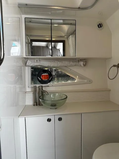 Slide: The Image of 2024 Sea Ray Sundancer 320 bathroom with modern sink and mirrored cabinet. - 14
