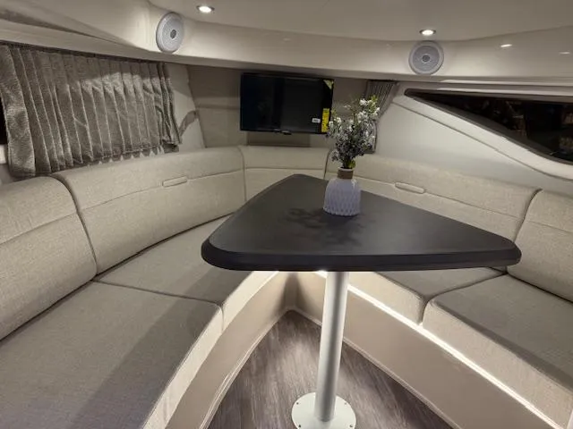 Slide: The Image of 2024 Sea Ray Sundancer 320 interior with elegant seating and table arrangement. - 15