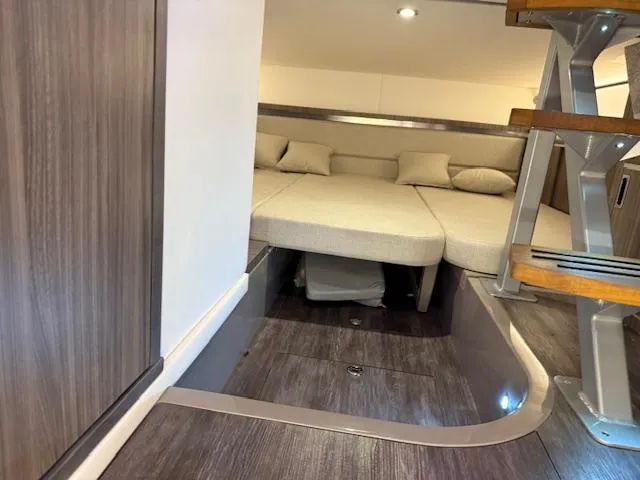 Slide: The Image of 2024 Sea Ray Sundancer 320 cabin interior with modern design and comfortable seating. - 17