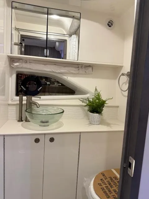 Slide: The Image of 2024 Sea Ray Sundancer 320 bathroom with modern sink and mirror. - 20