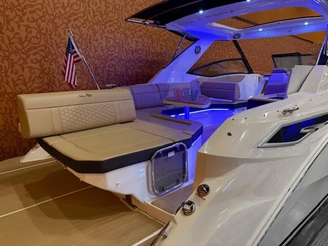 Slide: The Image of 2024 Sea Ray Sundancer 320 interior with elegant seating and ambient lighting. - 3