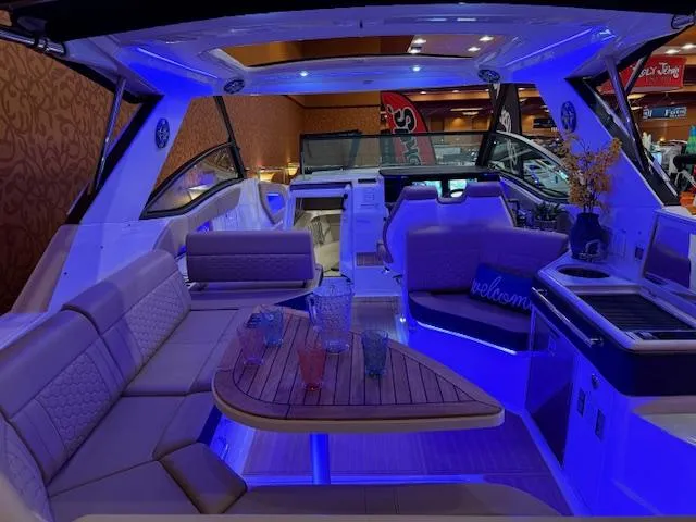 Slide: The Image of 2024 Sea Ray Sundancer 320 interior with blue LED lighting and luxurious seating. - 4
