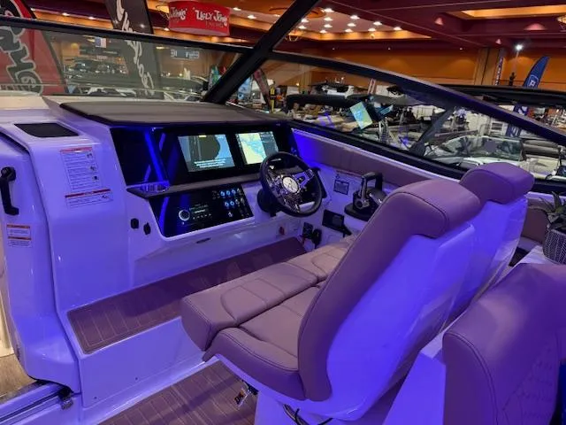 Slide: The Image of 2024 Sea Ray Sundancer 320 helm with modern controls and illuminated dashboard. - 7