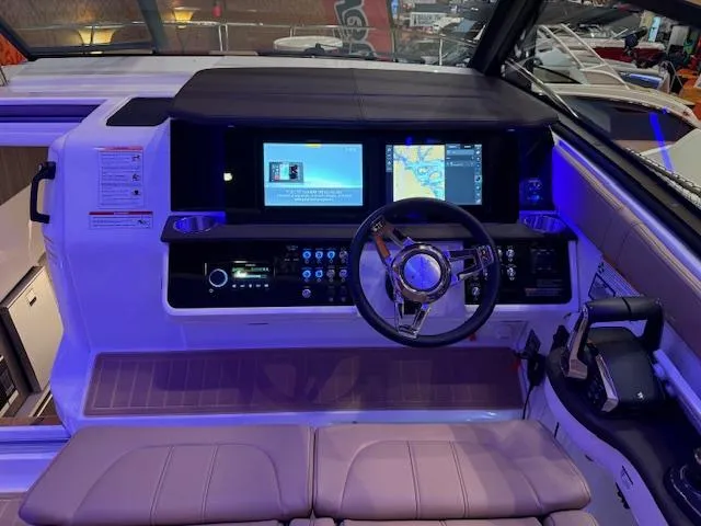Slide: The Image of 2024 Sea Ray Sundancer 320 helm with modern navigation displays and controls. - 8