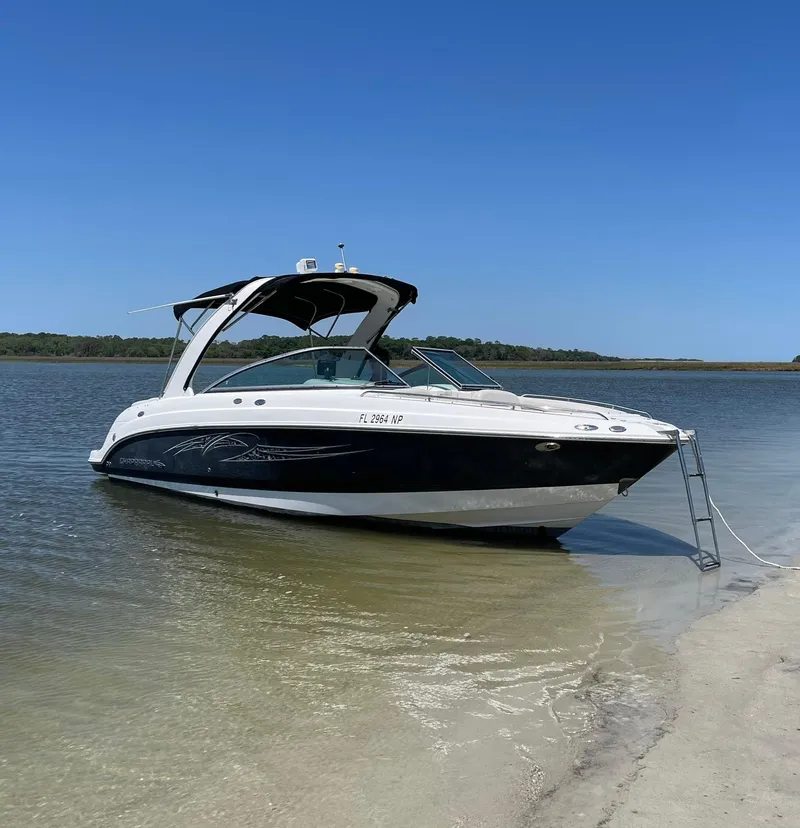 The Image of 2007 Chaparral 256 SSi boat anchored on a sandy beach. - 0