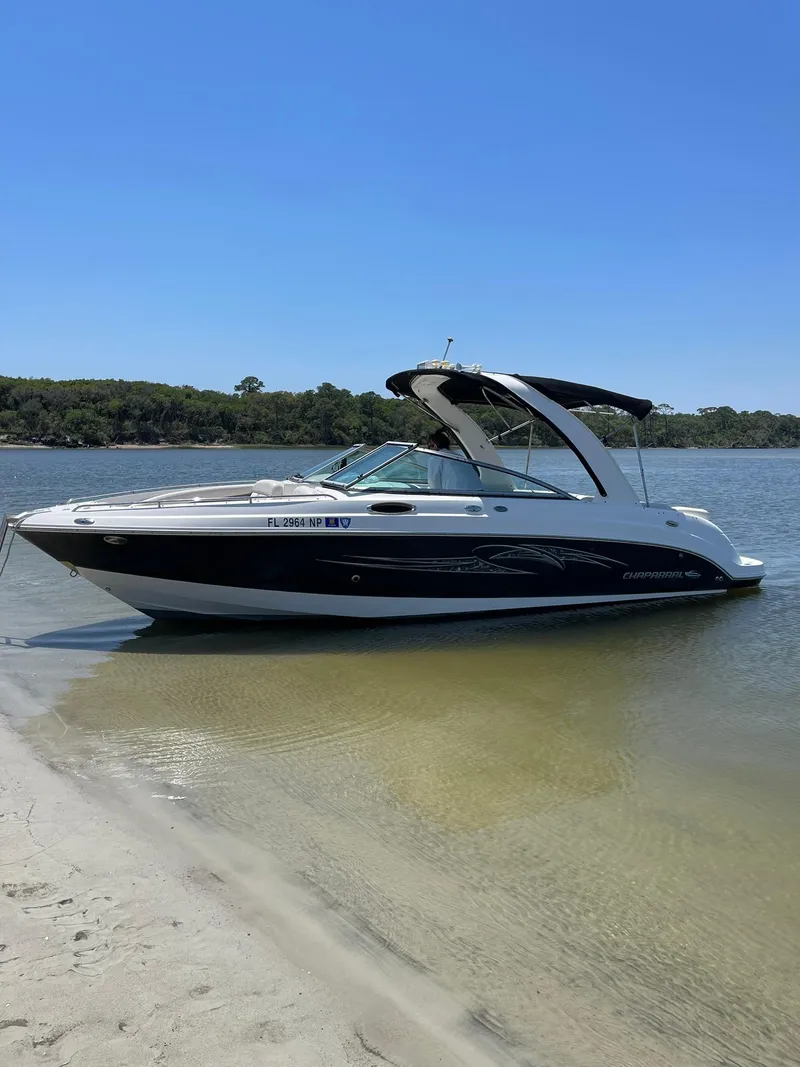 Slide: The Image of 2007 Chaparral 256 SSi boat anchored on a sandy beach. - 1