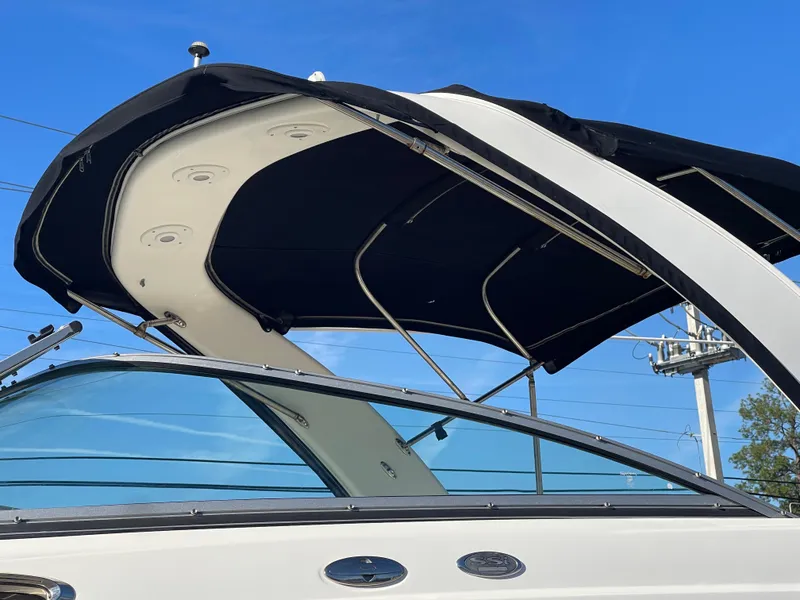 Slide: The Image of 2007 Chaparral 256 SSi boat with black canopy against blue sky. - 10