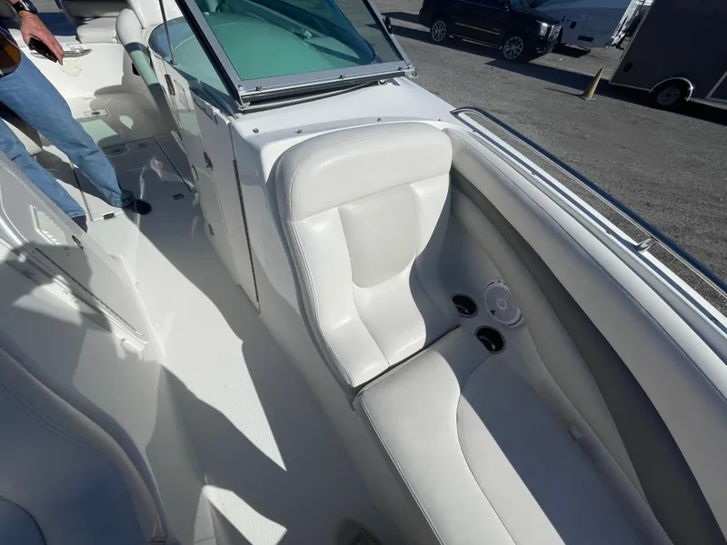 Slide: The Image of 2007 Chaparral 256 SSi boat interior with white seating and cup holders. - 14
