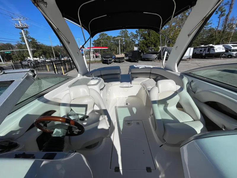Slide: The Image of 2007 Chaparral 256 SSi boat interior with white seating and steering wheel. - 15