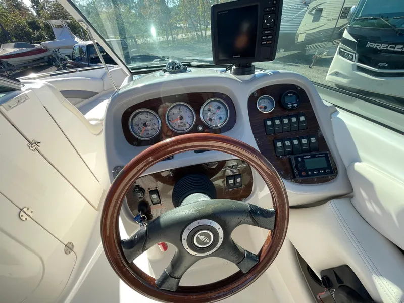 Slide: The Image of 2007 Chaparral 256 SSi boat dashboard with steering wheel and gauges. - 18