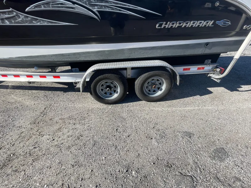Slide: The Image of 2007 Chaparral 256 SSi boat on a dual-axle trailer, parked on asphalt. - 37