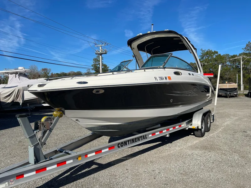 Slide: The Image of 2007 Chaparral 256 SSi boat on trailer, parked outdoors under clear blue sky. - 5