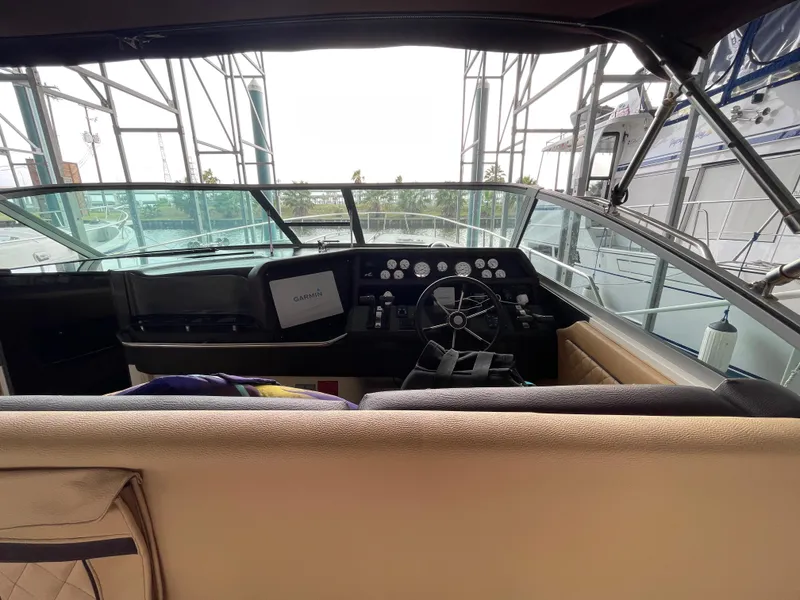 Slide: The Image of Luxurious 1993 Sea Ray 370 Sundancer interior with tan seating and colorful fish decor. - 11