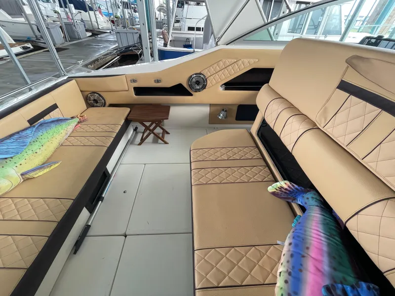 Slide: The Image of Interior of 1993 Sea Ray 370 Sundancer with tan seating and colorful cushions. - 12