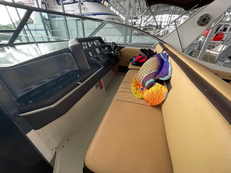 Slide: The Image of 1993 Sea Ray 370 Sundancer helm with gauges and steering wheel. - 13