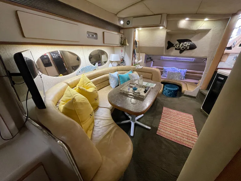 Slide: The Image of Interior of 1993 Sea Ray 370 Sundancer yacht with cozy seating and kitchenette. - 17