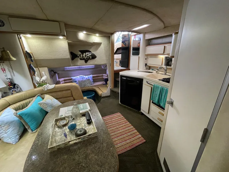 Slide: The Image of Cozy interior of 1993 Sea Ray 370 Sundancer with plush seating and decorative pillows. - 18