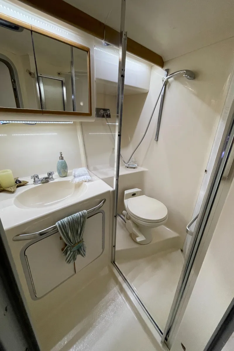 Slide: The Image of Interior of 1993 Sea Ray 370 Sundancer with plush fish decor on tan seating. - 22