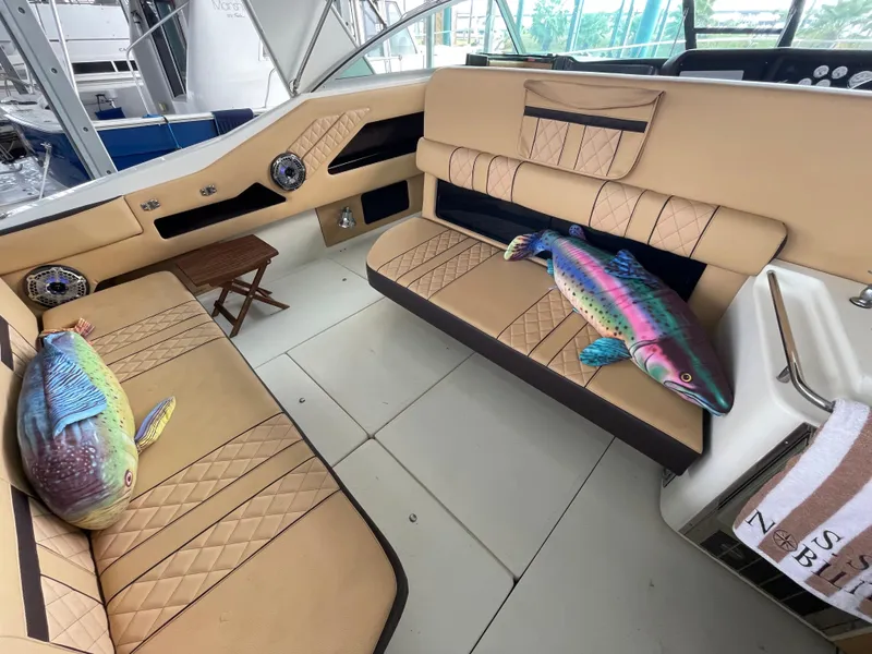 Slide: The Image of Interior of 1993 Sea Ray 370 Sundancer with tan seating and fish pillow. - 23
