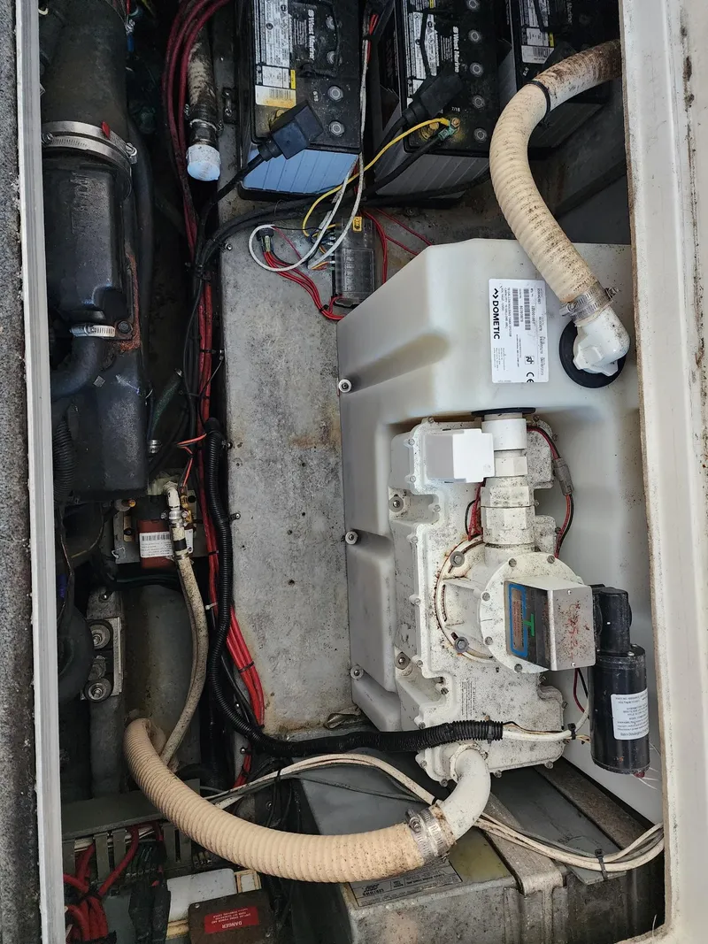 Slide: The Image of Engine compartment of 1993 Sea Ray 370 Sundancer boat, showcasing mechanical components and wiring. - 27