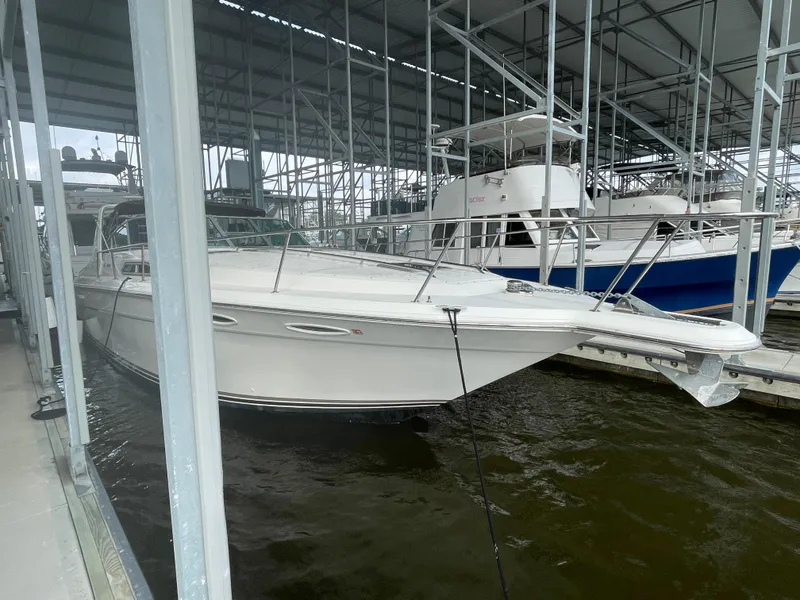 Slide: The Image of 1993 Sea Ray 370 Sundancer docked in a marina under a covered structure. - 4