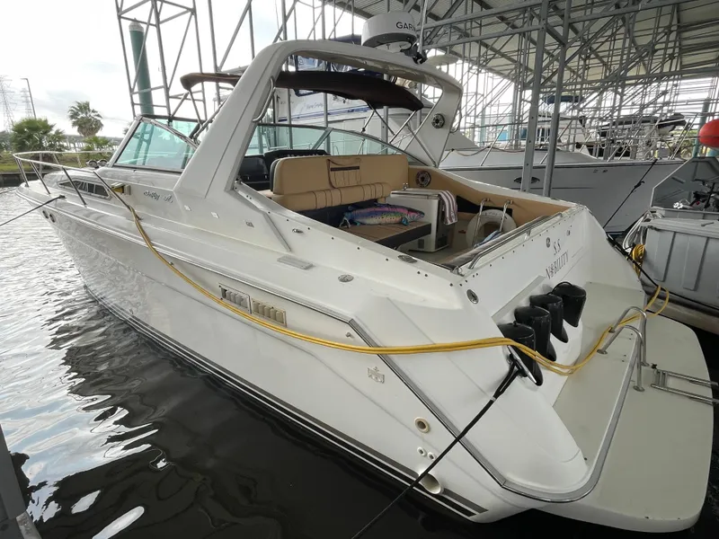 Slide: The Image of 1993 Sea Ray 370 Sundancer docked in marina under shelter. - 7