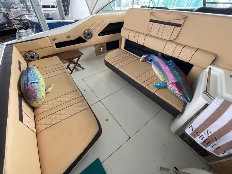 Slide: The Image of 1993 Sea Ray 370 Sundancer interior with plush seating and colorful fish decor. - 9