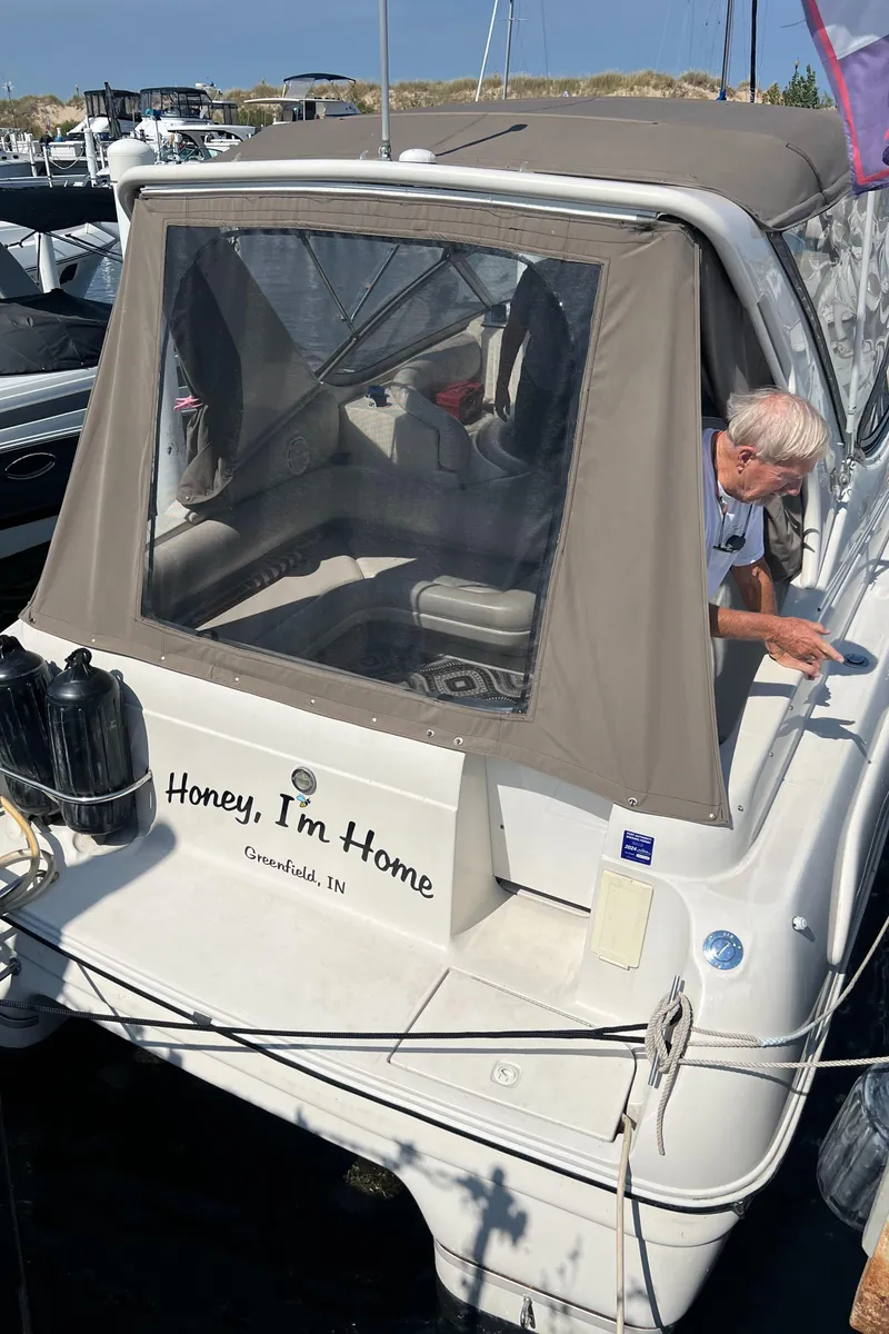 Slide: The Image of 1998 Regal 292 Commodore boat docked, featuring "Honey, I'm Home" text on the stern. - 4