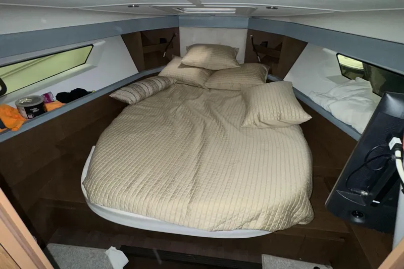 Slide: The Image of Interior cabin of 1998 Regal 292 Commodore with cozy bed and pillows. - 8