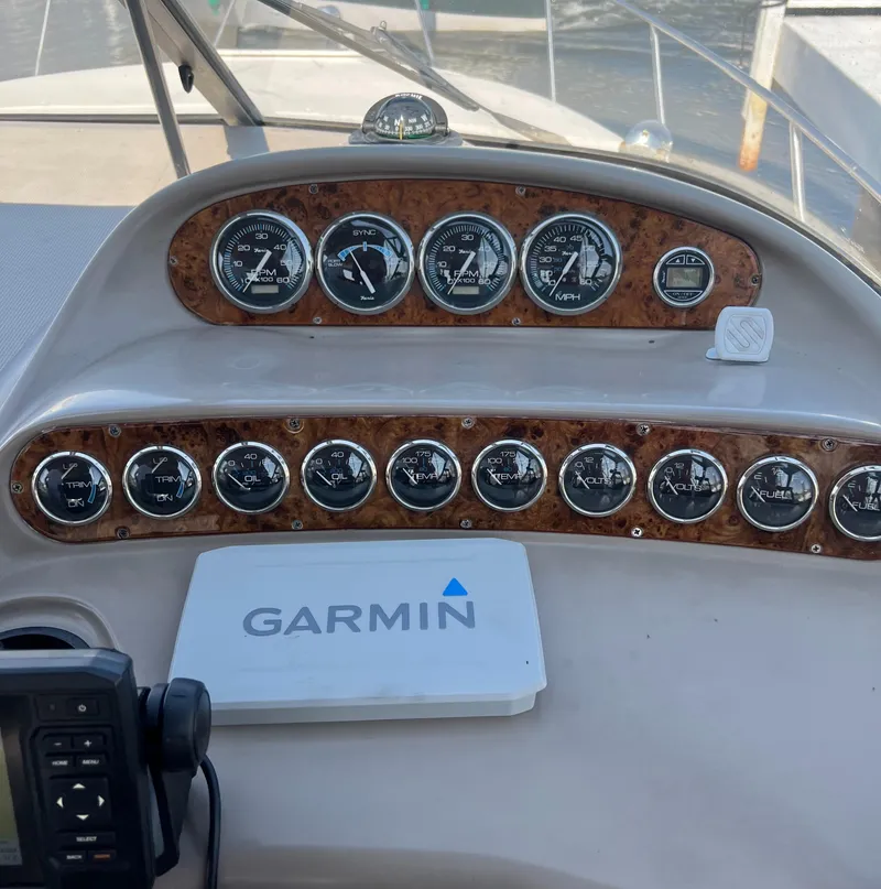 Slide: The Image of 1998 Regal 292 Commodore dashboard with Garmin navigation system and gauges. - 9