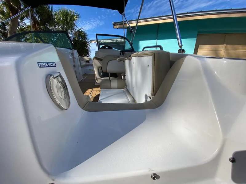 Slide: The Image of 2022 NauticStar 223 DC boat interior with seating and fresh water access. - 15