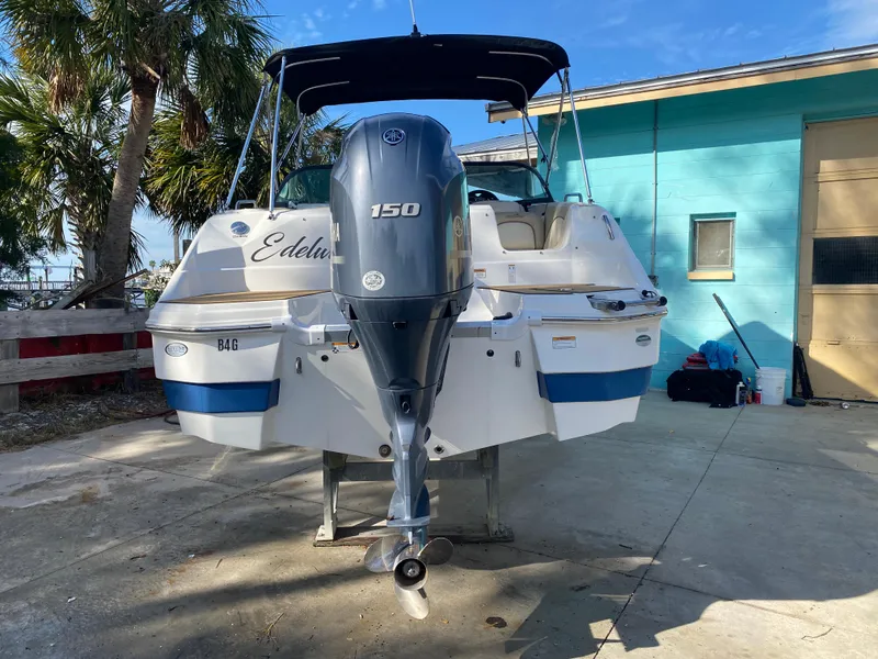 Slide: The Image of 2022 NauticStar 223 DC boat with Yamaha 150 engine, parked outdoors. - 2