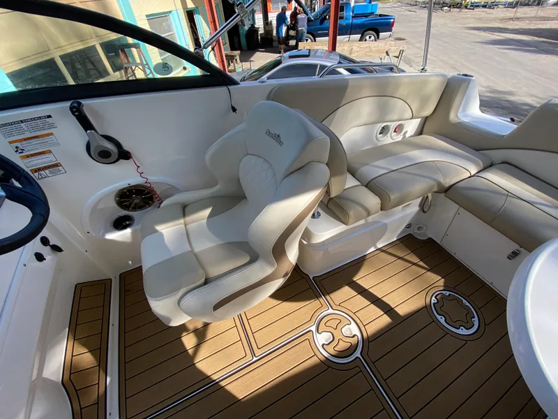 Slide: The Image of 2022 NauticStar 223 DC boat interior with beige seating and wood-patterned flooring. - 20