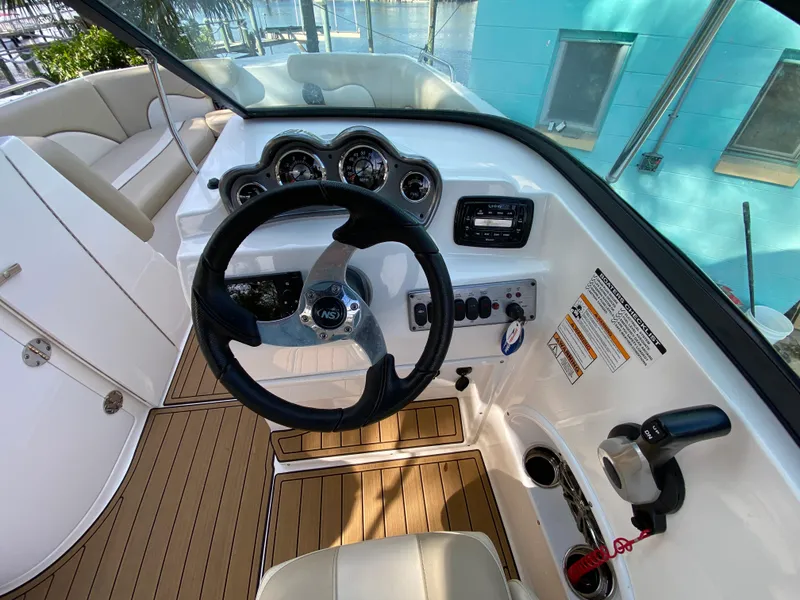 Slide: The Image of 2022 NauticStar 223 DC boat cockpit with steering wheel and control panel. - 24