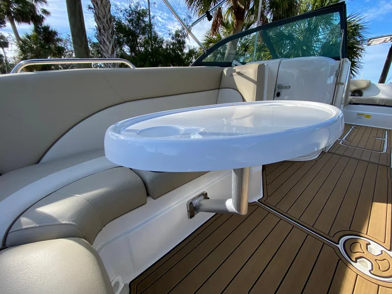Slide: The Image of 2022 NauticStar 223 DC boat interior with seating and table, featuring teak flooring. - 31