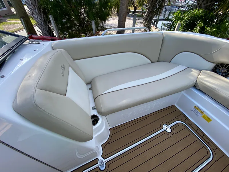 Slide: The Image of 2022 NauticStar 223 DC boat interior with beige seating and wood-style flooring. - 34