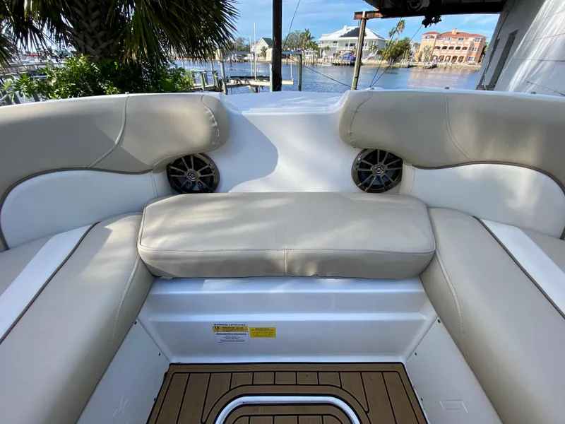 Slide: The Image of 2022 NauticStar 223 DC boat interior with beige seating and waterfront view. - 36