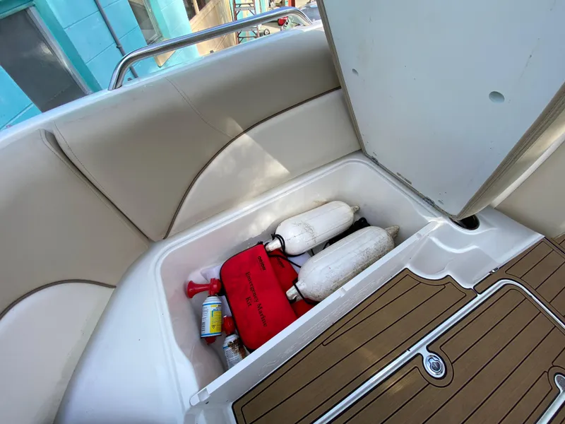 Slide: The Image of Storage compartment on 2022 NauticStar 223 DC boat with safety equipment. - 45