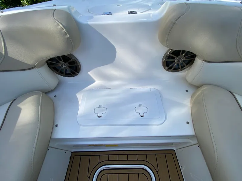Slide: The Image of 2022 NauticStar 223 DC boat interior with beige seating and speakers. - 46