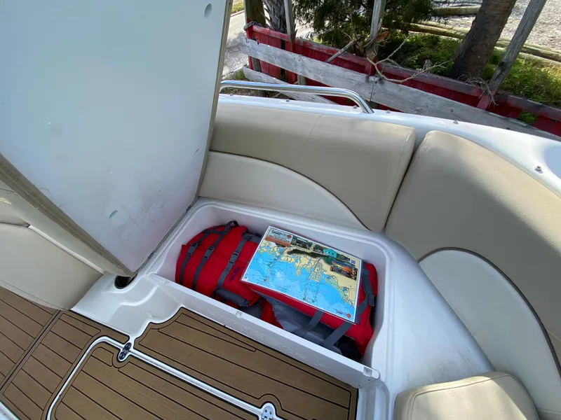 Slide: The Image of Storage compartment in 2022 NauticStar 223 DC boat with map and red bag. - 48