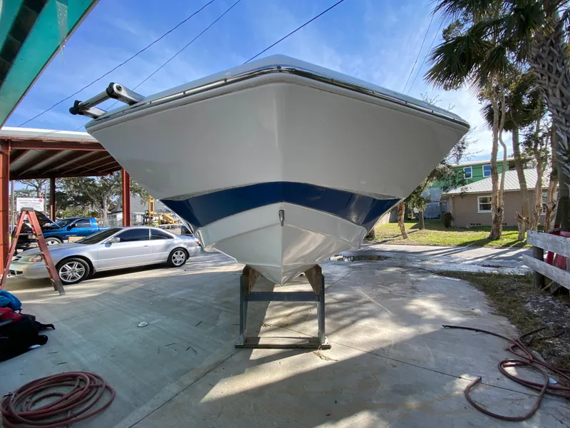 Slide: The Image of 2022 NauticStar 223 DC boat on trailer, parked outdoors. - 6