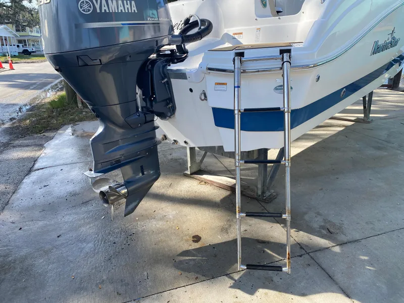 Slide: The Image of 2022 NauticStar 223 DC boat with Yamaha outboard motor and ladder. - 7