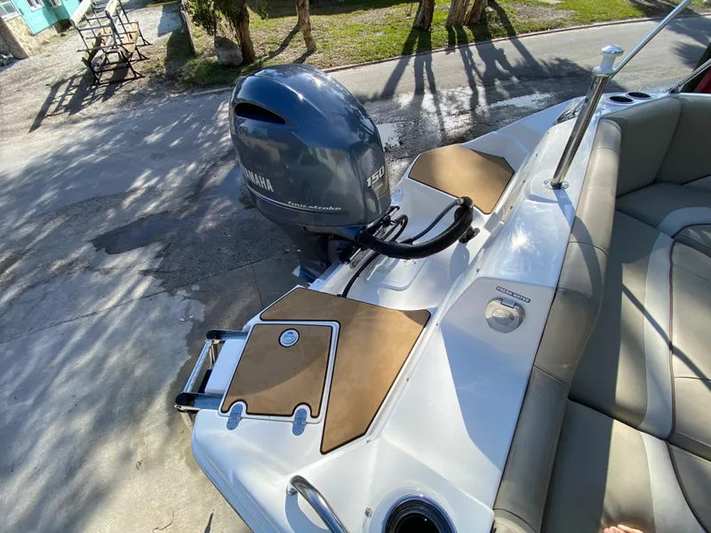 Slide: The Image of 2022 NauticStar 223 DC boat with Yamaha outboard motor, rear seating, and swim platform. - 9