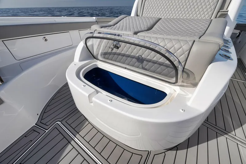 Slide: The Image of 2024 Valhalla Boatworks V-46 with open storage compartment and cushioned seating. - 15