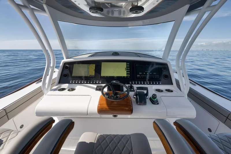 Slide: The Image of 2024 Valhalla Boatworks V-46 helm with advanced navigation displays on open sea. - 22
