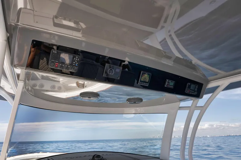 Slide: The Image of 2024 Valhalla Boatworks V-46 helm with advanced navigation equipment on open water. - 23