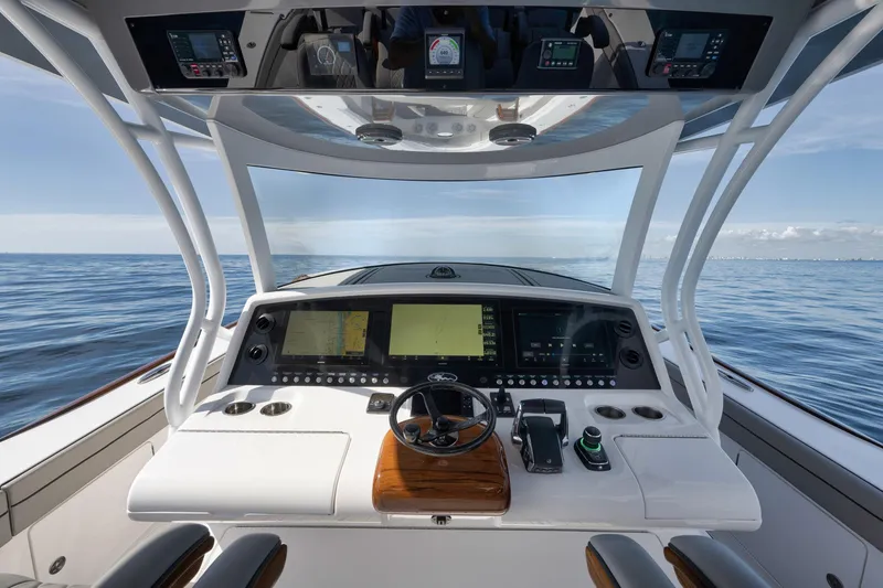 Slide: The Image of 2024 Valhalla Boatworks V-46 helm with advanced navigation systems on open sea. - 24