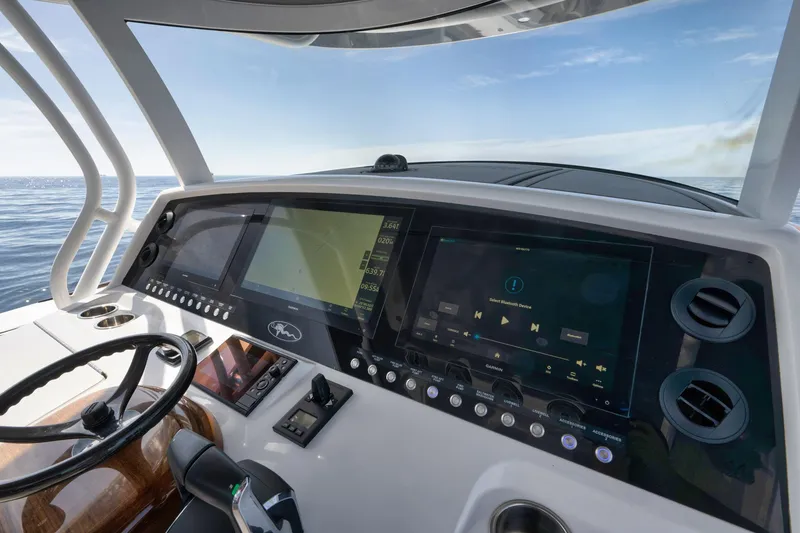 Slide: The Image of 2024 Valhalla Boatworks V-46 helm with advanced navigation displays and steering wheel. - 27