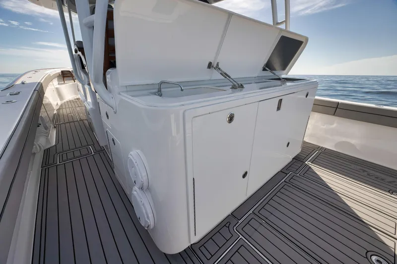 Slide: The Image of 2024 Valhalla Boatworks V-46 deck with storage compartments and ocean view. - 38